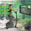 Vrouw zittend op Tunturi Hometrainer E50 voor TV met aansluiting Tunturi Routes app